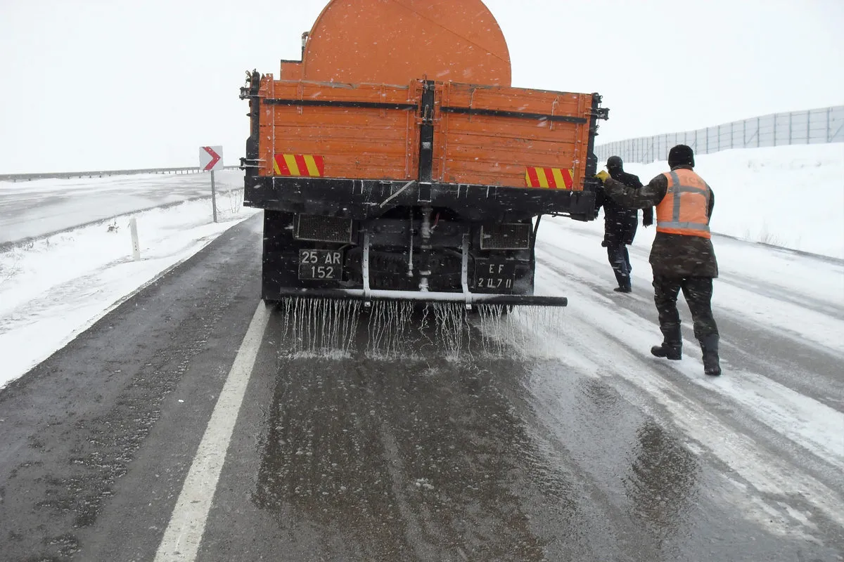 Road truck spraying de-icing chemical on highway for winter safety